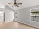 Large bedroom with wood floors, ceiling fan, and view of the bathroom at 860 Crestridge Cir, Tarpon Springs, FL 34688