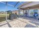 Covered patio with grill and seating area overlooking the backyard at 8618 Tidal Bay Ln, Tampa, FL 33635