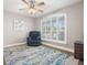 Cozy bedroom with plush carpeting, ceiling fan, and large window at 10944 Trelain Way, Hudson, FL 34667