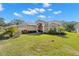 Inviting one-story home with a lush green lawn and landscaped gardens at 10944 Trelain Way, Hudson, FL 34667