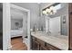 Modern bathroom with granite countertop, dark wood cabinets, and bedroom view at 12816 Starling Dr, Odessa, FL 33556