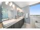 Bright bathroom with double sinks, and bathtub at 15 Avalon St # 704, Clearwater Beach, FL 33767