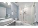 Bathroom featuring modern vanity, sink, toilet, and glass door shower at 15 Avalon St # 704, Clearwater Beach, FL 33767