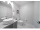 Modern powder room with vessel sink, decorative mirror and stone floors at 15 Avalon St # 704, Clearwater Beach, FL 33767