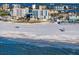 Wide sandy beach along the ocean and a condominium complex, with views of the city in the distance at 15 Avalon St # 704, Clearwater Beach, FL 33767