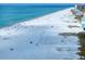 Breathtaking beach scene featuring people, soft sand, clear ocean and a vibrant shoreline in this aerial shot at 15 Avalon St # 704, Clearwater Beach, FL 33767