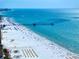 Expansive beach view featuring pier, ocean, beachgoers, and hotels in this beautiful aerial shot at 15 Avalon St # 704, Clearwater Beach, FL 33767