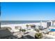 A beautiful beach view with white sand and buildings in the background on a clear day at 15 Avalon St # 704, Clearwater Beach, FL 33767