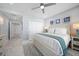 Coastal bedroom with white furniture, ceiling fan, and blue accents throughout the room at 15 Avalon St # 704, Clearwater Beach, FL 33767