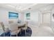 Elegant dining room with stylish chandelier, table setting, and beautiful artwork at 15 Avalon St # 704, Clearwater Beach, FL 33767