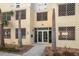 Building entrance with prominent address number and professional signage, enhanced by decorative palm trees at 15 Avalon St # 704, Clearwater Beach, FL 33767