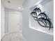 Hallway features a recessed art niche with dolphin sculpture and marble floors at 15 Avalon St # 704, Clearwater Beach, FL 33767