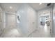 Hallway with marble floors, blue walls, and white doors leads into the bedrooms at 15 Avalon St # 704, Clearwater Beach, FL 33767
