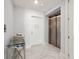 Hallway with a modern glass top chrome console table and shell with glass balls decor, and an elevator at 15 Avalon St # 704, Clearwater Beach, FL 33767