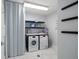 Bright laundry room features a Miele washer and dryer and decor accents at 15 Avalon St # 704, Clearwater Beach, FL 33767