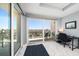 Bright room with large windows, balcony, and a small desk at 15 Avalon St # 704, Clearwater Beach, FL 33767