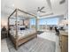 Spacious main bedroom features a four-poster bed, great light, and city views at 15 Avalon St # 704, Clearwater Beach, FL 33767