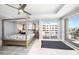 Light and airy main bedroom with sliding glass doors leading to a balcony at 15 Avalon St # 704, Clearwater Beach, FL 33767