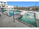 Rooftop pool and hot tub area with lounge chairs at 15 Avalon St # 704, Clearwater Beach, FL 33767
