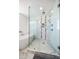 Modern glass shower with dual shower heads, white tile, and pebble shower floor at 15 Avalon St # 704, Clearwater Beach, FL 33767