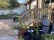 Back patio with potted plants and stairs at 1529 Paloma Ln, Dunedin, FL 34698