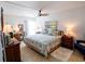 Main bedroom with king-size bed, dresser, and sitting area at 1655 S Highland Ave # F227, Clearwater, FL 33756