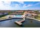 An aerial view showcasing the community pool, shuffleboard courts, and waterfront access at 19029 Us Highway 19 # 25D, Clearwater, FL 33764