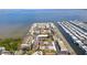 Aerial view of waterfront community with red roofs, showcasing proximity to the open water at 19029 Us Highway 19 # 25D, Clearwater, FL 33764