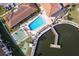 Aerial view of community pool, shuffleboard courts, and pier access to the water at 19029 Us Highway 19 # 25D, Clearwater, FL 33764