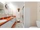 Bright bathroom featuring double sinks, a glass-enclosed shower, and ample counter space at 19029 Us Highway 19 # 25D, Clearwater, FL 33764