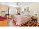 Cozy bedroom with pink bedding, ceiling fan, and tile floor at 19029 Us Highway 19 # 25D, Clearwater, FL 33764