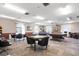 Spacious game room with pool table, card tables, and comfortable chairs at 19029 Us Highway 19 # 25D, Clearwater, FL 33764