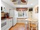 Kitchen with white cabinets, copper countertops, and an eat-in area at 19029 Us Highway 19 # 25D, Clearwater, FL 33764