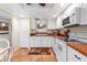 Bright kitchen with white cabinets, white appliances, and tile floor at 19029 Us Highway 19 # 25D, Clearwater, FL 33764