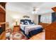 Large main bedroom with blue and white bedding, ceiling fan, and tile floor at 19029 Us Highway 19 # 25D, Clearwater, FL 33764