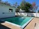 Inviting backyard pool with a white privacy fence, perfect for relaxation and outdoor entertainment at 1948 Jeffords St, Clearwater, FL 33764
