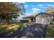 Front view of house showing driveway and landscaping at 2186 Marshall Dr, Dunedin, FL 34698