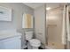 Bright bathroom featuring white cabinets, a quartz countertop, and a glass shower enclosure at 2323 Feather Sound Dr # 310, Clearwater, FL 33762