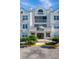 Front view of a white residential building with balconies and a covered entrance at 2323 Feather Sound Dr # 310, Clearwater, FL 33762