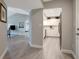 Hallway view into a modern kitchen with white cabinets and stainless steel appliances at 2323 Feather Sound Dr # 310, Clearwater, FL 33762