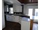 Updated kitchen featuring white cabinetry, marble counters, and wood ceiling at 24 160Th Ct, Redington Beach, FL 33708