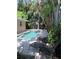 Inviting pool with lounge chairs and tropical plants at 24 160Th Ct, Redington Beach, FL 33708