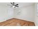 Bright bedroom with wood floors, ceiling fan, and closet at 3322 W Dorchester St, Tampa, FL 33611