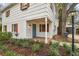 Welcoming front porch with blue door, charming light fixture, and brick walkway at 3322 W Dorchester St, Tampa, FL 33611