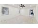 Living room with white walls, large windows, and terrazzo floors at 3322 W Dorchester St, Tampa, FL 33611