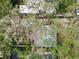 Aerial close-up view of a house's roof amidst dense tree coverage at 3322 W Dorchester St, Tampa, FL 33611