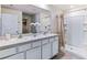 Bright main bathroom with double vanities, a shower, and modern fixtures at 5345 Oxford Gray Rd, Wesley Chapel, FL 33545