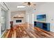 Living room with hardwood floors, fireplace, and built-in entertainment center at 3625 Greatwood Ct, Land O Lakes, FL 34639