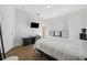 Bedroom with king-size bed, TV mount and hardwood floors at 4810 W Mcelroy Ave # 2, Tampa, FL 33611