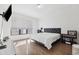 Main bedroom with a king-size bed, hardwood floors, and large window at 4810 W Mcelroy Ave # 2, Tampa, FL 33611